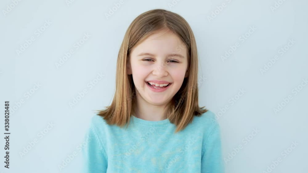 Positive little girl laughing indoors Positive little girl laughing indoors
