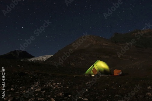 tent in the mountains under stars