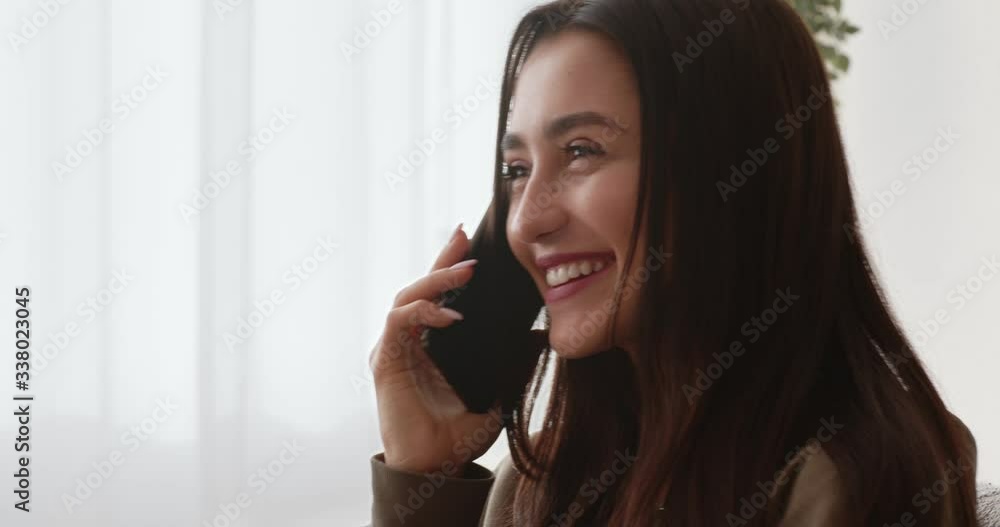Happy girl flirting with boyfriend by cellphone, side view Happy girl flirting with boyfriend by cellphone, side view