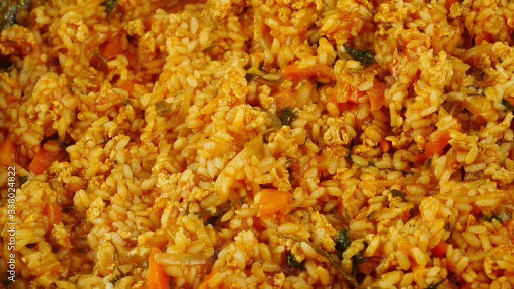 Uzbek pilaf.Closeup,rotate.Rice with meat and vegetables.Bright,juicy dish. Uzbek pilaf.Closeup,rotate.Rice with meat and vegetables.Bright,juicy dish.