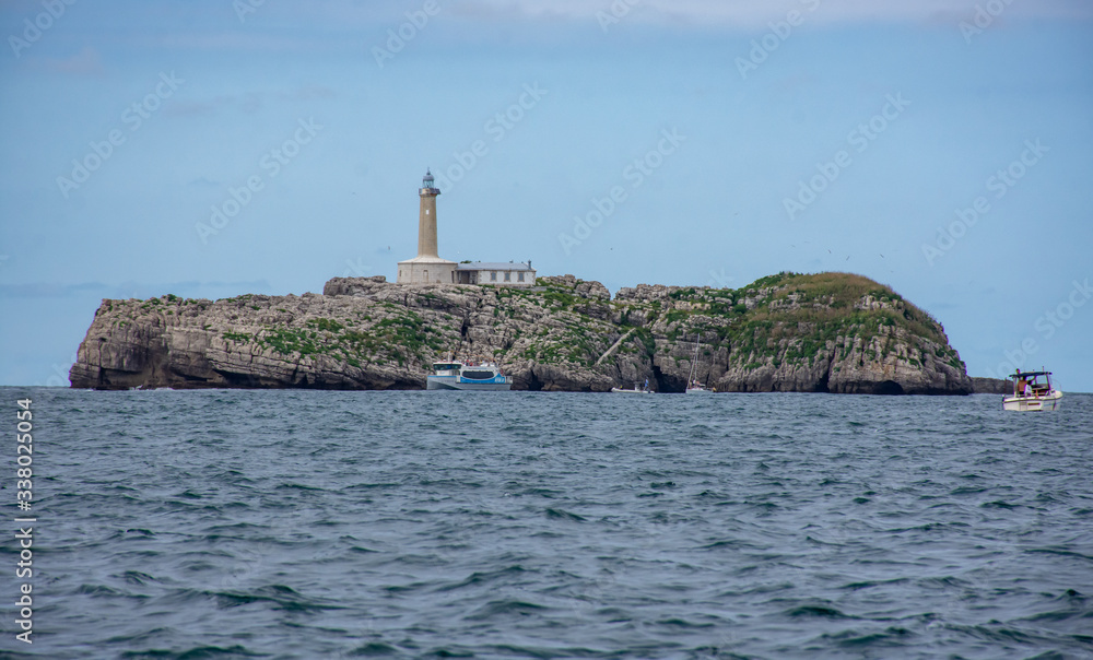 lighthouse island on calm day