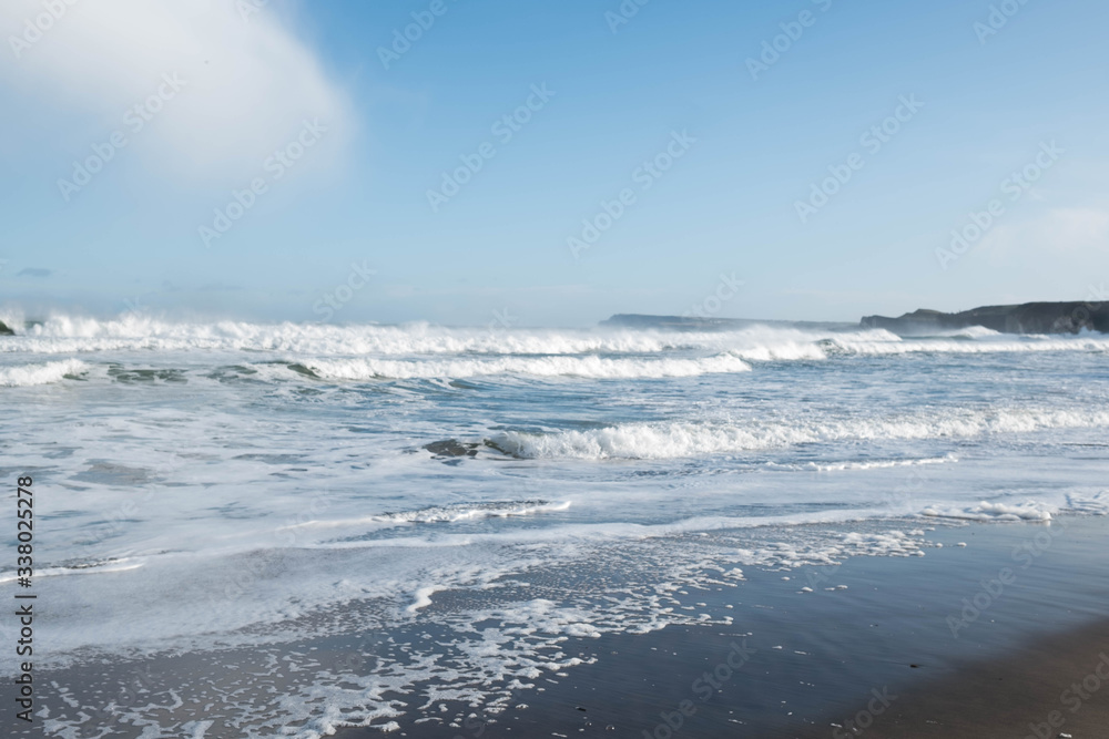 Waves crash on the beach on the North Antrim coast
