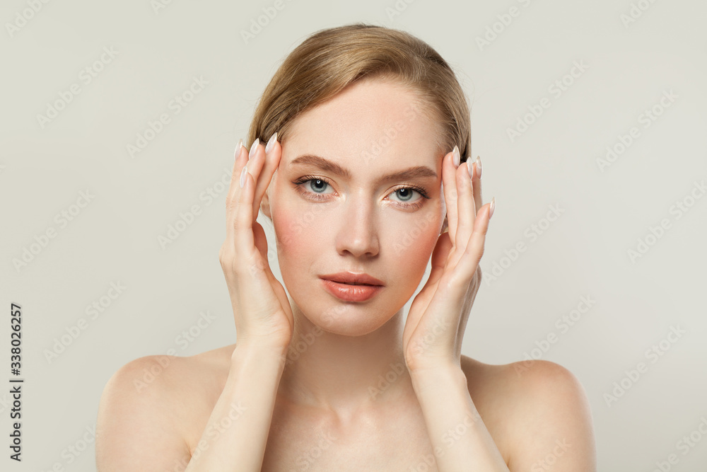Young woman with clear skin. Skincare and facial treatment concept