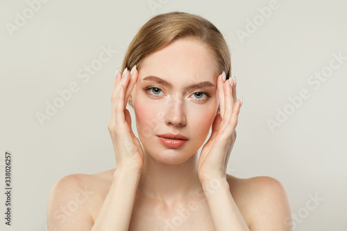 Young woman with clear skin. Skincare and facial treatment concept
