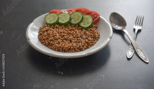 vegetarian food buckwheat with vegetables on the table