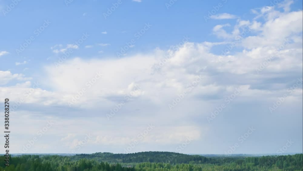 Aerial time lapse of summer blue sky with flying clouds over the green valley. View from the top of the hill. 4k Aerial time lapse of summer blue sky with flying clouds over the green valley. View from the top of the hill. 4k