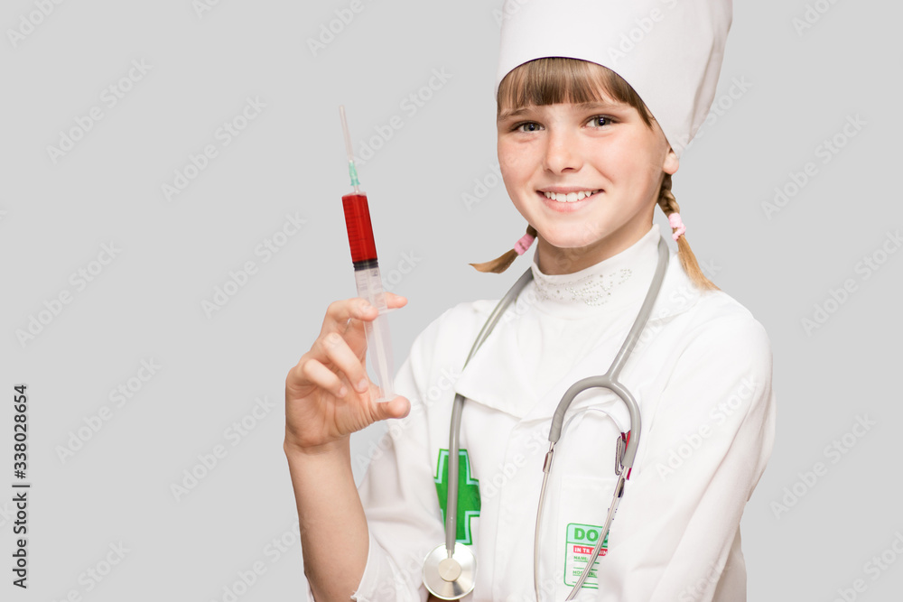 Smiling kid girl playing doctor with syringe isolated on white Smiling kid girl playing doctor with syringe isolated on white
