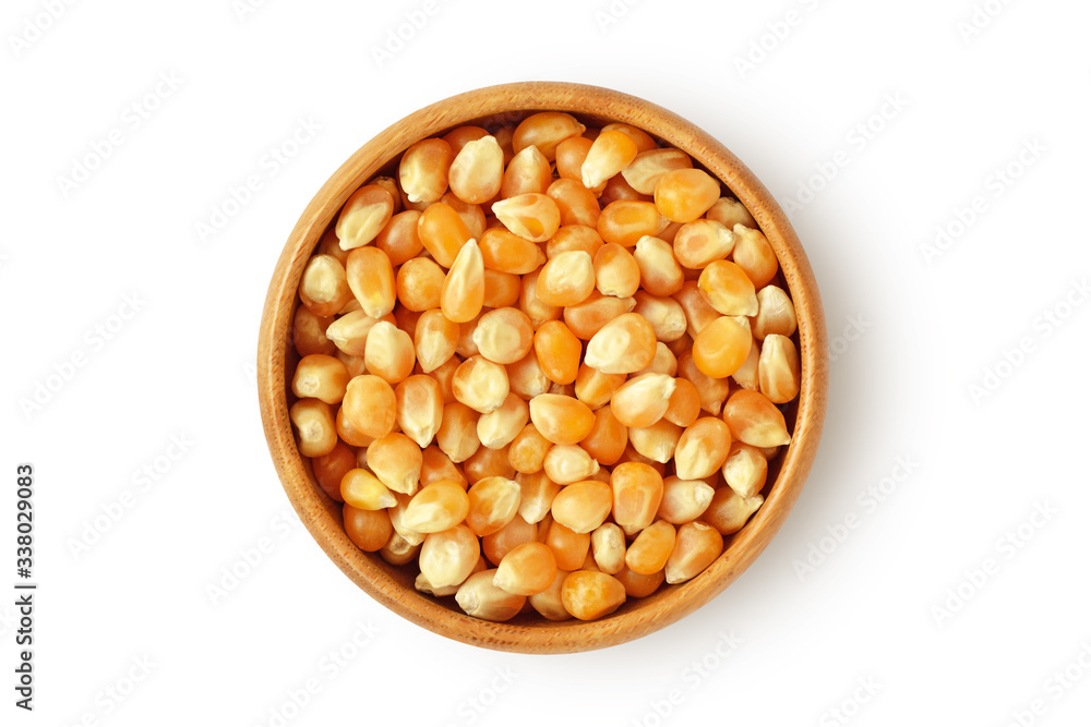 Dried corn kernels in wooden bowl on white background Dried corn kernels in wooden bowl on white background