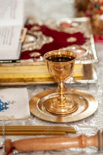 church gold chalice with wine on the golden plate