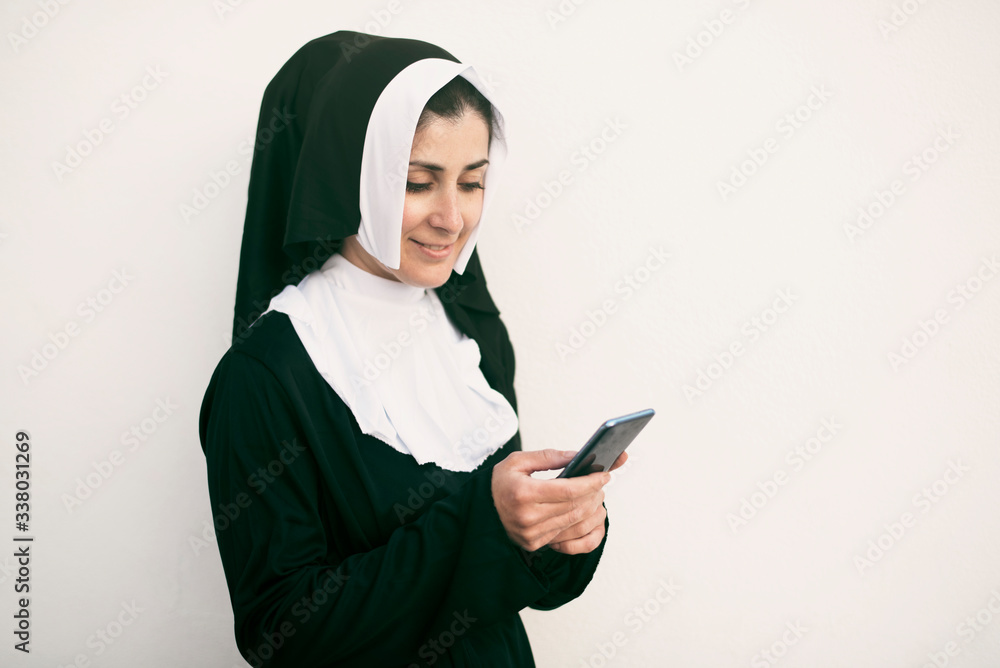 nun with smart phone on white background nun with smart phone on white background