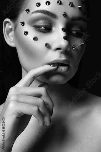 girl in steel mask. beautiful girl with spikes on her Face