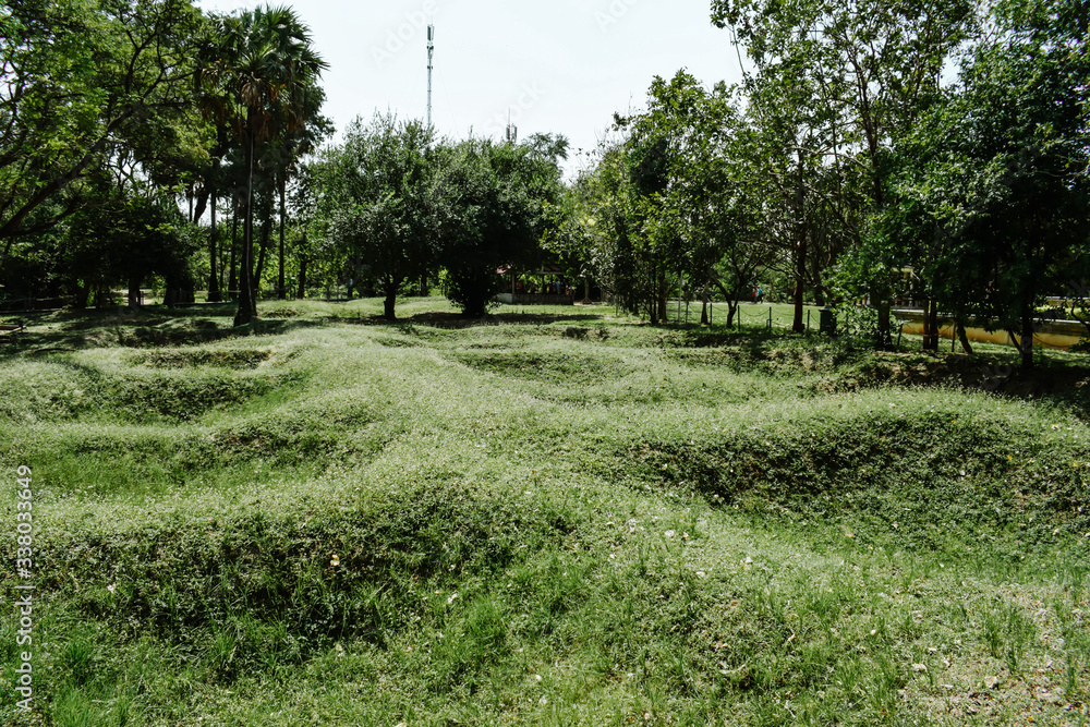 Mass graves of Khmer Rouge victims in the Cambodia Killing Fields Choeung Ek Genocidal Center Phnom Penh