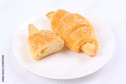 Fresh and tasty croissant on white background