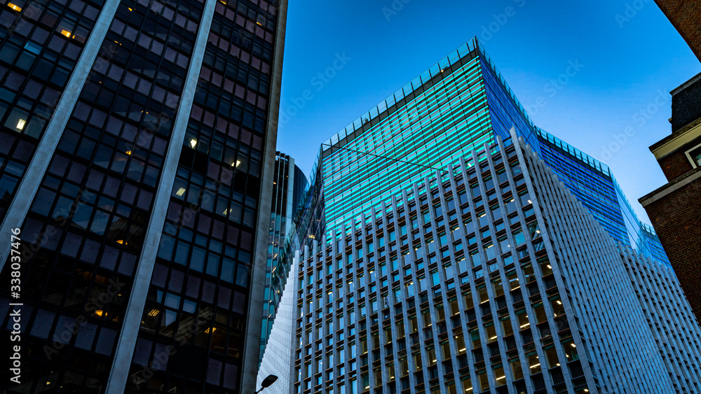 Looking up at tall skyscrapers at sunset 