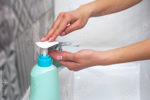 Hand washing. A woman uses soap to wash her hands. hygiene concept