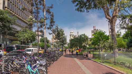Red cycling track in the Jose Larco avenue and bicycle parking timelapse hyperlapse in Miraflores, Lima Peru photo