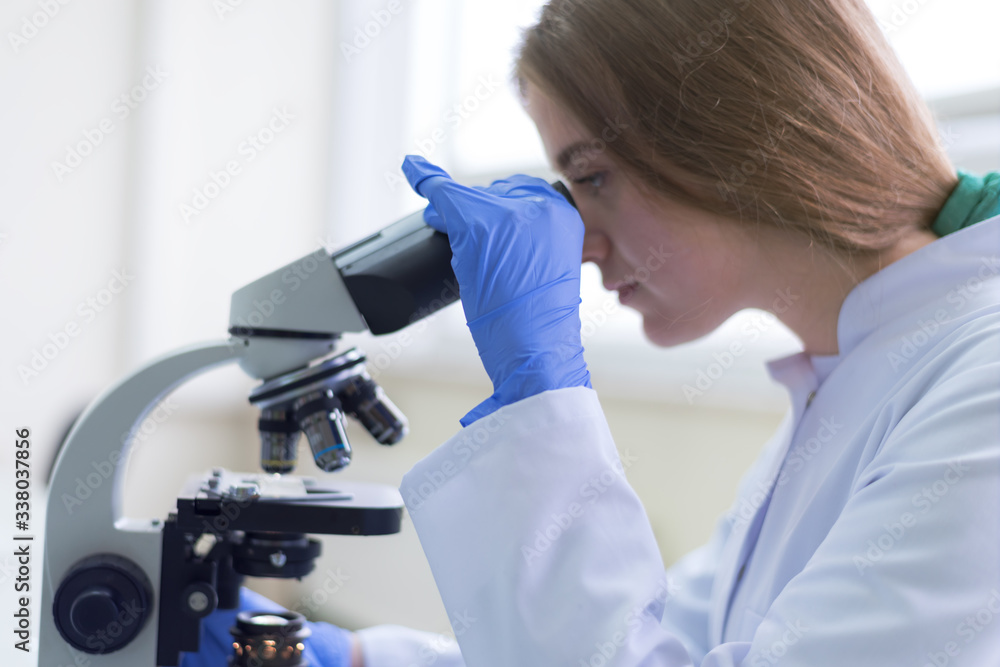 Young female Laboratory scientist working at lab with test tubes, test or research in clinical laboratory.Science, chemistry, biology, medicine and people concept. Young female Laboratory scientist working at lab with test tubes, test or research in clinical laboratory.Science, chemistry, biology, medicine and people concept.