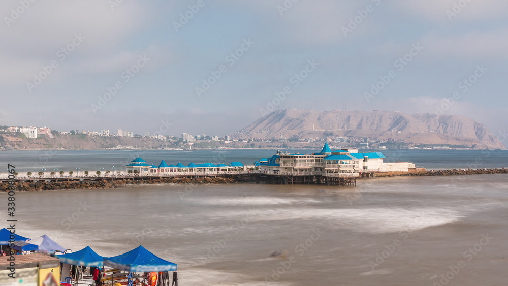 Aerial view of the Pier taken from the pebble beach. Restaurant is located at the end of the pier timelapse. Miraflores, Lima, Peru