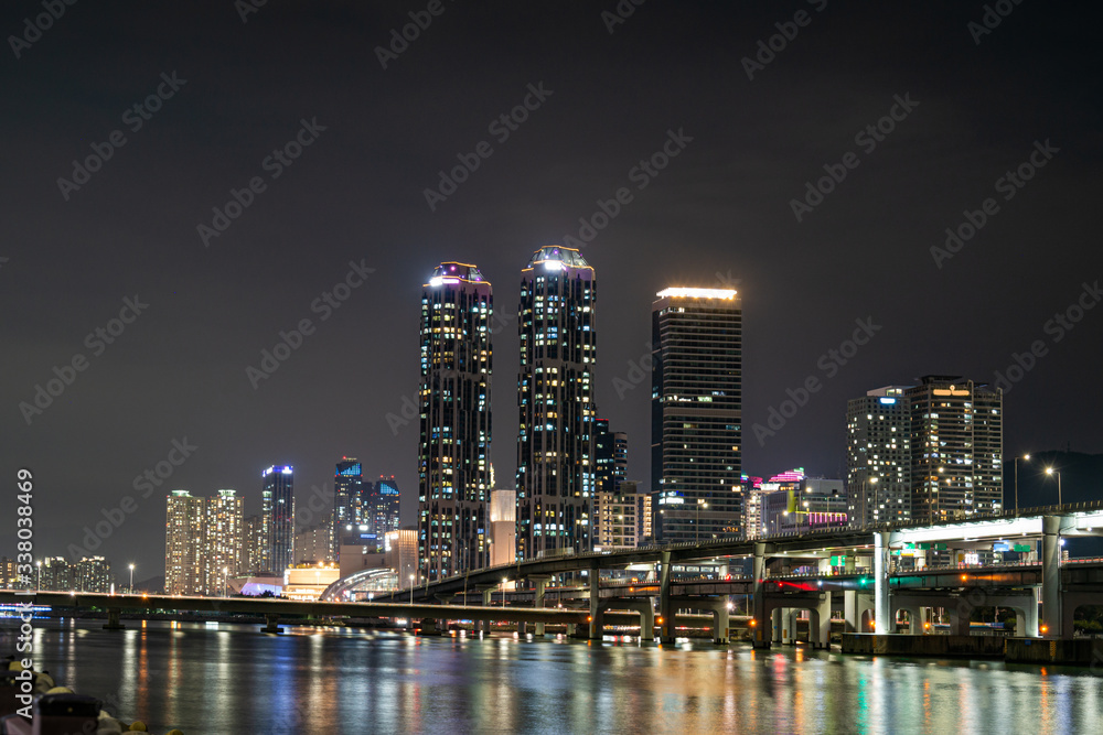 The night view of skyscraper and city and sea in Haeundae district,  Busan, South Korea