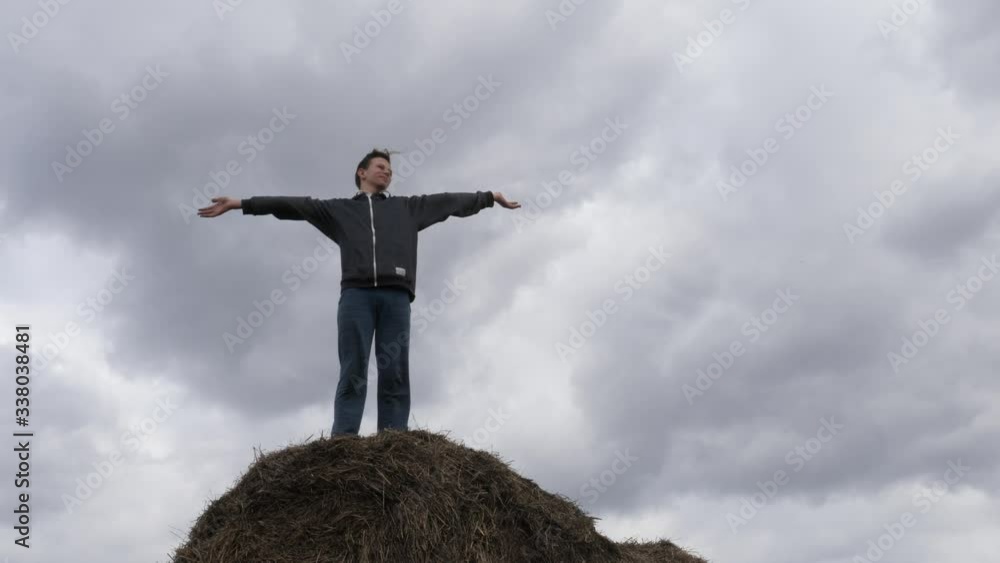 child play with a stack of straw against the sky child play with a stack of straw against the sky