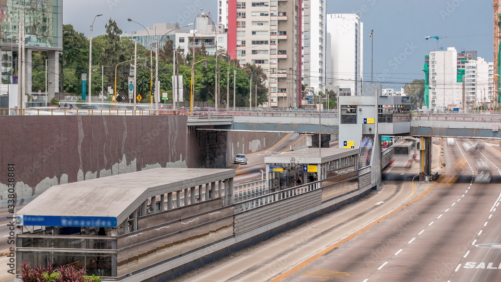 Obraz premium Aerial view of Via Expresa highway and metropolitan bus with traffic timelapse and blue sky with clouds. Lima, Peru