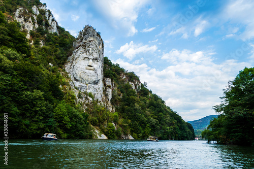 The face of the Dacian king Decebal. Panoramic view of the Danube river.  photo