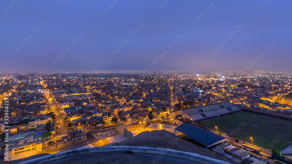 Fototapeta premium Panoramic skyline of Lima city from above with many buildings aerial night to day transition timelapse. Lima, Peru