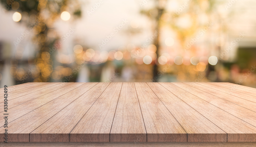 Wooden top table with bokeh light effect and blur restaurant on background, blur background Wooden top table with bokeh light effect and blur restaurant on background, blur background