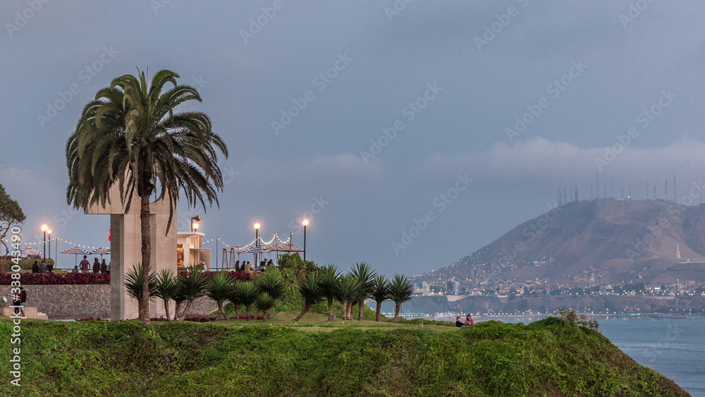 Intihuatana park with panoramic view of Miraflores district and Morro Solar hill on a background day to night timelapse, in Lima, Peru