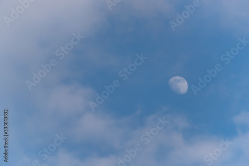 Three Quarter Moon in a Blue Sky with Clouds