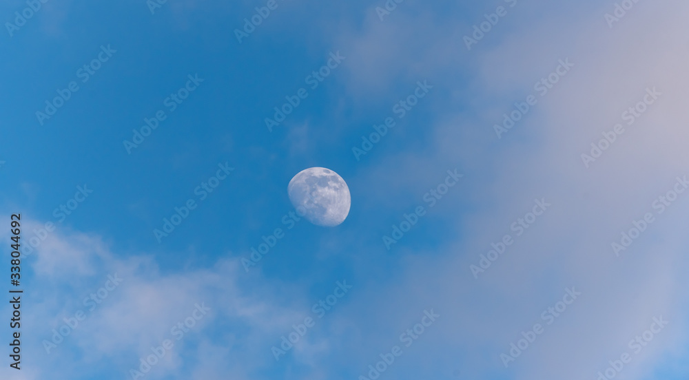Three Quarter Moon in a Blue Sky with Clouds Three Quarter Moon in a Blue Sky with Clouds