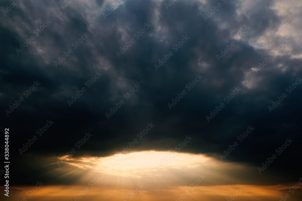Atmospheric and mesmerizing sunset in cloudy weather. The shape of a circle and a tunnel. Landscape and weather forecast