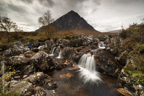 Beautiful Waterfall At Buachaille Etive Mor In The Scottish Highlands on cloudy weather..