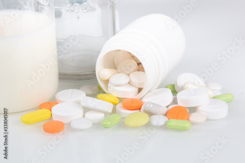 Medical pills and Glassware with white liquids for laboratory analysis. Laboratory medical research, chemical lab.