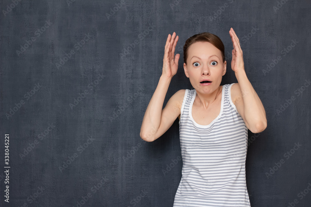 Portrait of shocked surprised girl raising hands up Portrait of shocked surprised girl raising hands up