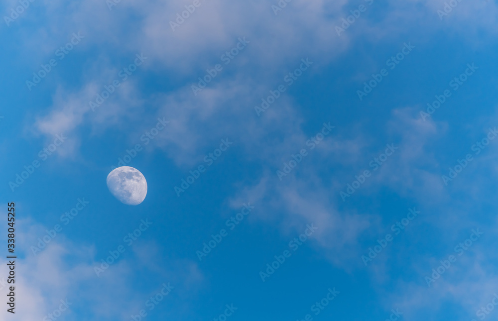 Three Quarter Moon in a Blue Sky with Clouds Three Quarter Moon in a Blue Sky with Clouds
