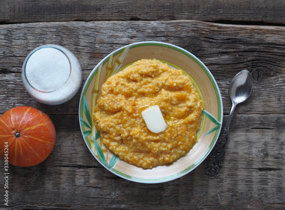 Millet porridge with pumpkin on wooden background. Healthy eating concept. Millet porridge with pumpkin on wooden background. Healthy eating concept.