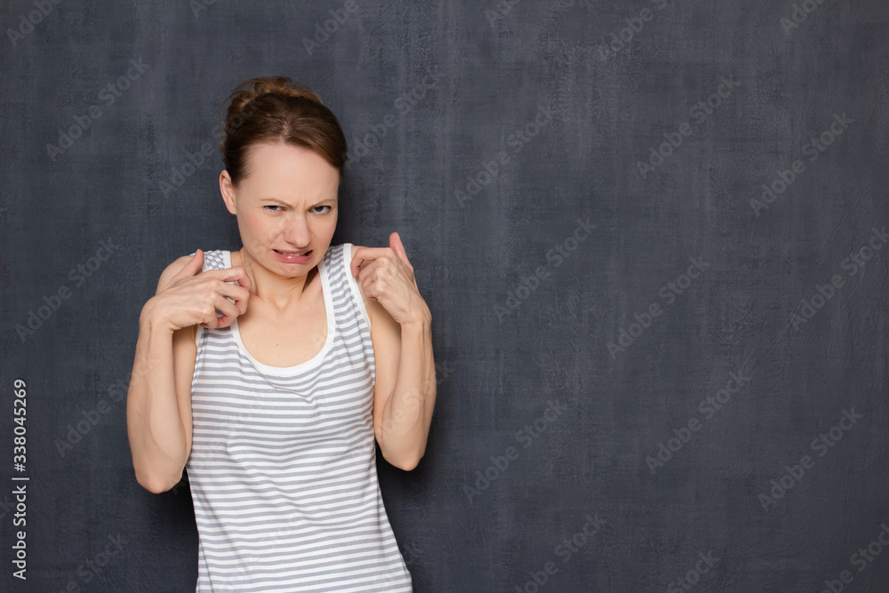 Portrait of displeased girl grimacing from disgust and raising hands Portrait of displeased girl grimacing from disgust and raising hands