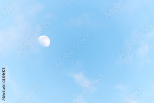 Three Quarter Moon in a Blue Sky with Clouds