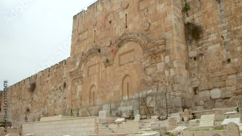 View of the Golden gates in the Old City Walls of Jerusalem in Israel. It located in an ancient Muslim cemetery. Tilt up.