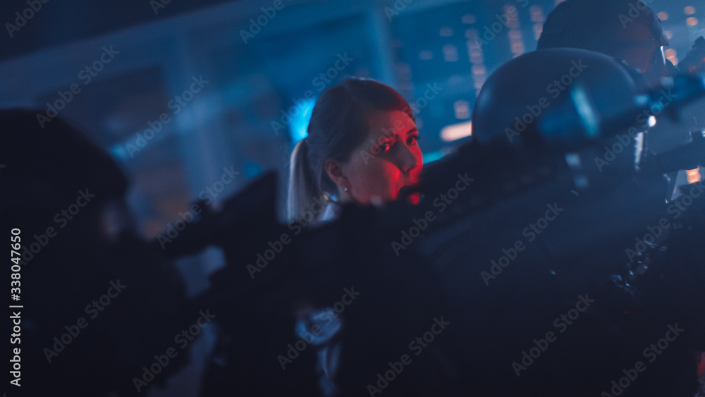 Masked Squad of Armed SWAT Police Officers Rescue a Female Hostage in a Dark Seized Office Building with Desks and Computers. Soldiers with Rifles and Flashlights Move Forwards and Cover Surroundings. Masked Squad of Armed SWAT Police Officers Rescue a Female Hostage in a Dark Seized Office Building with Desks and Computers. Soldiers with Rifles and Flashlights Move Forwards and Cover Surroundings.