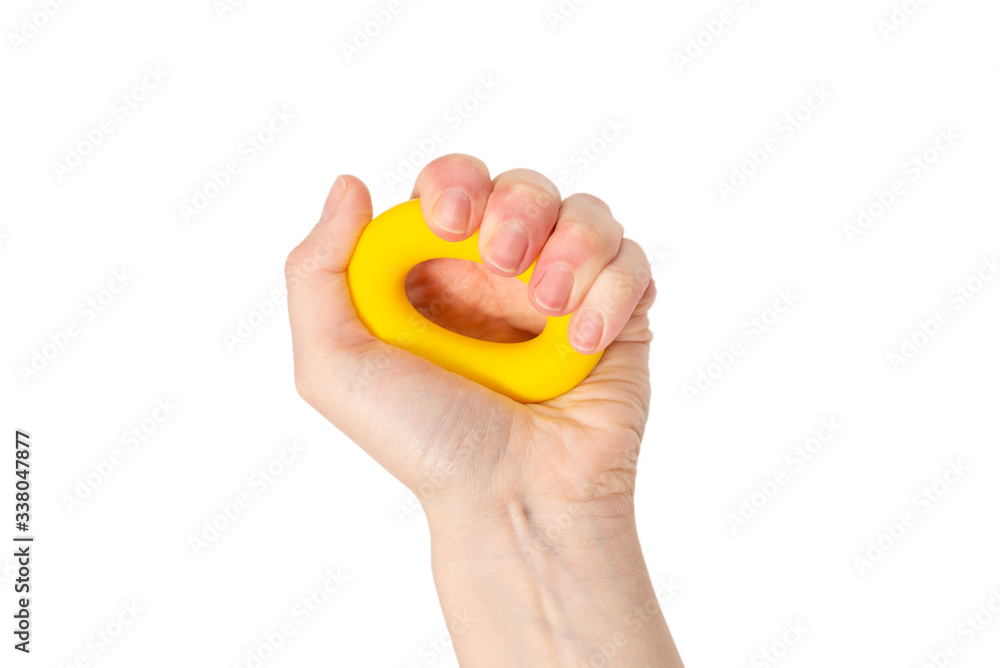 Yellow and orange expander in woman hand isolated on white background. Yellow and orange expander in woman hand isolated on white background.