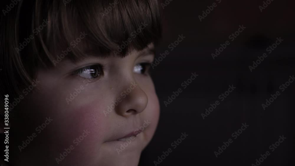 Portrait Сute Little Kid While Watching TV. Young Boy Watch Television on Living Room. Concept Video Game, Entertainment, Emotions, Family. Child Watching TV, Close up Face of Little Boy, Kid Eyes. Portrait Сute Little Kid While Watching TV. Young Boy Watch Television on Living Room. Concept Video Game, Entertainment, Emotions, Family. Child Watching TV, Close up Face of Little Boy, Kid Eyes.