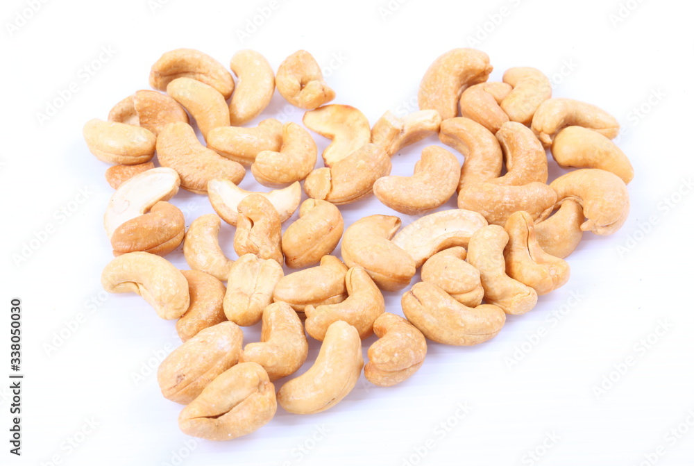 Roasted cashew nuts on white background Roasted cashew nuts on white background