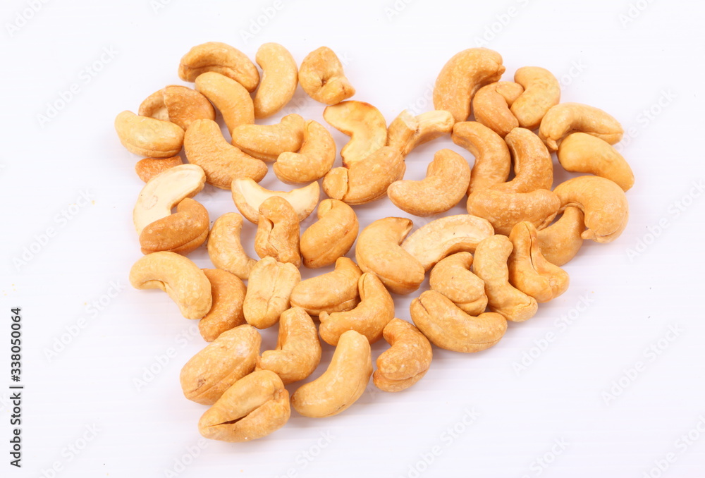 Roasted cashew nuts on white background Roasted cashew nuts on white background