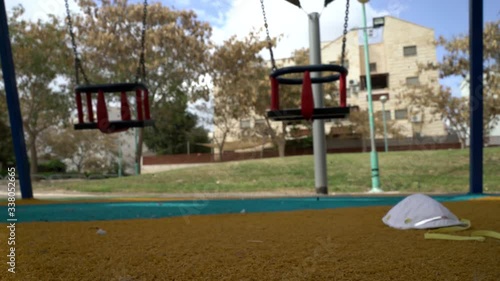 Wallpaper Mural Abandoned respiratory, medical face mask human on empty children playground. City quarantine. Coronavirus,  covid 19 epidemic. Worldwide  emergency situation. Virus protection. Spring sunny day. Torontodigital.ca