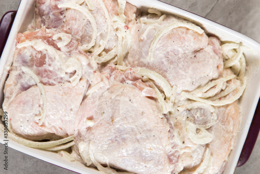 Chicken thighs with onions and mayonnaise, a simple recipe for homemade attraction, preparation for baking.