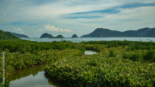 Puncak mandeh interesting viewpoint many small islands in distance and pristine jungle around in West Sumatra, Indonesia photo