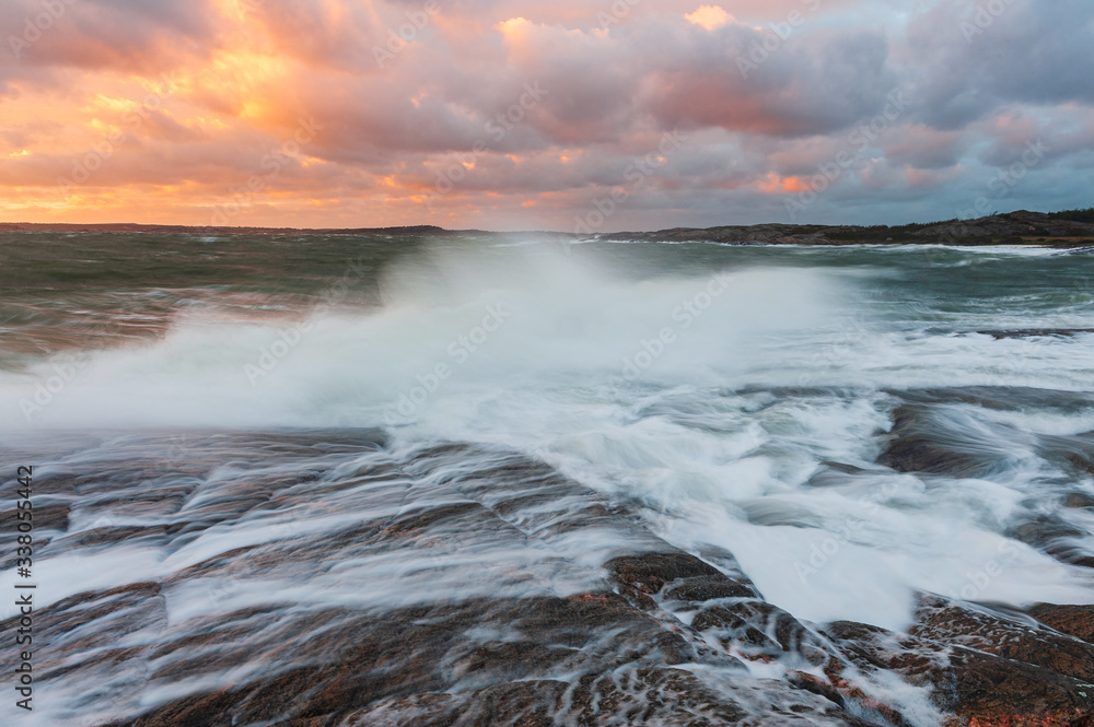 Waves crashing on beach at sunset, Sweden Waves crashing on beach at sunset, Sweden