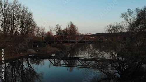 Aerial of an old railroad bridge over a river in a rural area